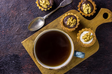 Obraz na płótnie Canvas espresso coffee accompanied by delicious almond biscuits cookies on a dark background