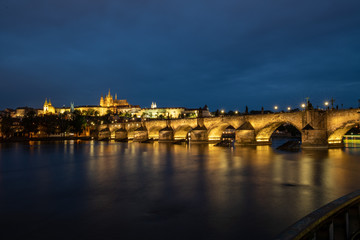 Fototapeta premium Prague, Czech Republic. Charles Bridge and Hradcany (Prague Castle) with St. Vitus Cathedral and St. George church evening dusk, Bohemia landmark in Praha.