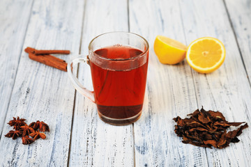 hot tea, cinnamon sticks, star anise, dried tea leaves and orange