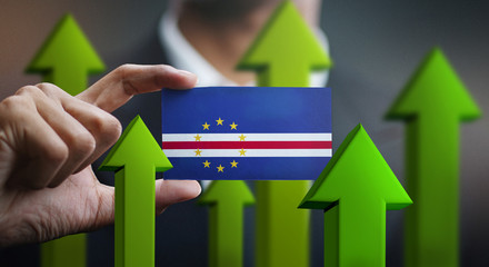 Nation Growth Concept, Green Up Arrows - Businessman Holding Card of Cape Verde Flag