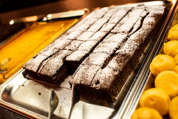 Chocolate cake on a tray in a self service restaurant