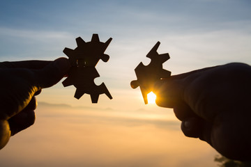Silhouette Woman hands connecting couple puzzle piece against sunrise, Business solutions, target,...