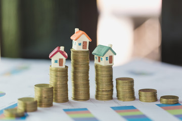 Mini house on stack of coins,Money and house,  Mortgage, Savings money for buy house and loan to...