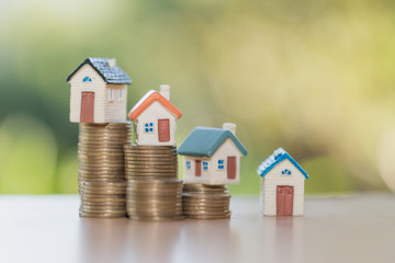 Mini house on stack of coins,Money and house, Real estate investment, Save money with stack coin, Mortgage concept.
