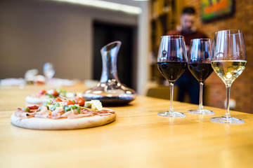 Decanter and glasses of red wine on the table at restaurant