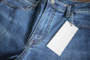 Blue jeans with blank white price label tag