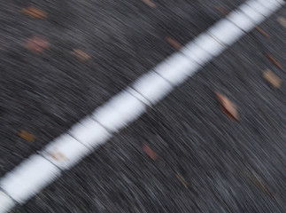 Diagonal line, white stripe on the road, blurred abstract