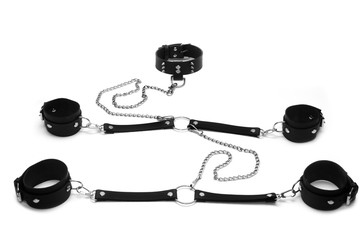 Black leather handcuffs, clamps on the hands, clamps on the legs and collar with spikes isolated on...