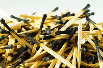 Burnt matches, big slide, close. Charred heads. Side view