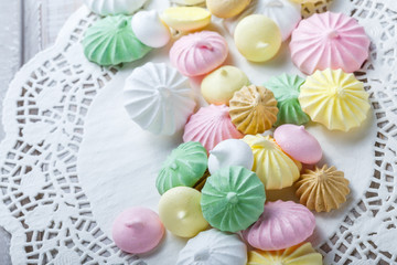 Colorful meringue cookies on napkin, natural light selective focus