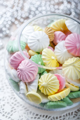 Colorful meringue cookies on napkin, natural light selective focus