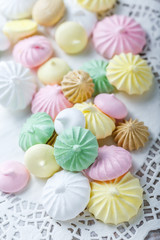 Colorful meringue cookies on napkin, natural light selective focus