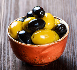 Bowls with different kind of olives green olives, black olives with olive oil