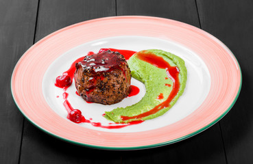 Grilled beef steak meat with berries and avocado sauce in plate. Hot Meat Dishes. Top view, flat lay