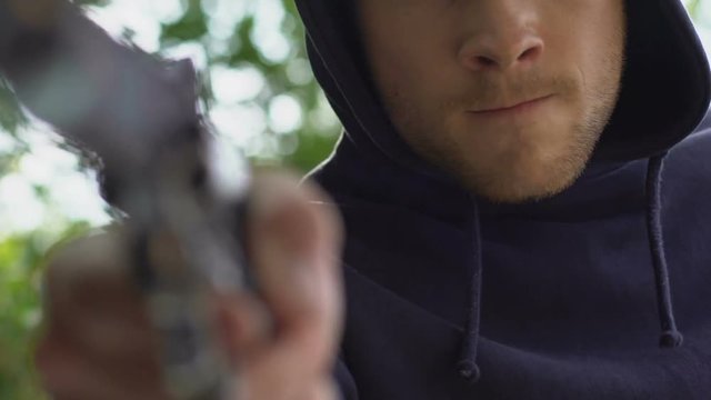 Pov of kidnapped person lying in trunk of car, murderer threatening with gun