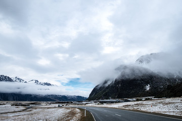 View of a road in Mount Cook Village covered with white fresh snow after a snowy day.
