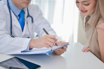 Health Concepts. The doctor is examining the patient's health. Patients are happy to come to the doctor. Medical examination results and Medical Consultation for Patients. The patient relaxes.