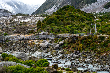 View of a swing bridge across the river in Hooker Valley Track. Mount Cook National Park.