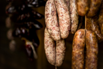 Fototapeta premium Smoked sausages hanging in a deli shop