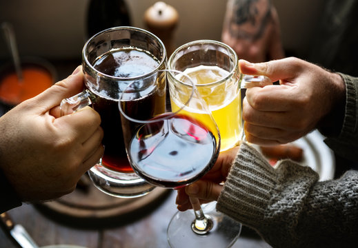 Group Of People Cheering With Glasses Of Alcohol