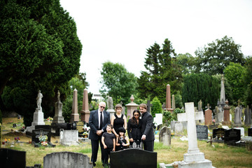Family giving their last goodbyes at the cemetery