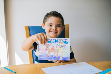 Cute boy showing off his artwork