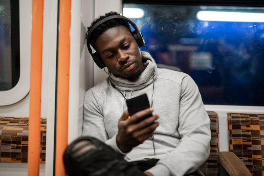 Bored man texting while on the train