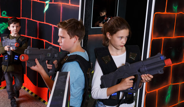 Girl and boy playing laser tag