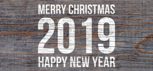 Marry Christmas and Happy New Year 2019, white text on wooden scratched wall