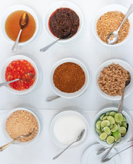 Thai flavouring sugar, fish sauce, vinegar, chilli powder, lemon and Peanut Powder in Glasses