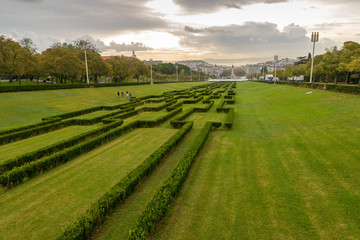 Fototapeta na wymiar LISBON, PORTUGAL - NOVEMBER 22, 2018: The central lane of Eduardo VII Park, with Lisbon and the Tagus river in the background