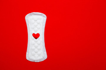 menstruation concept. a menstrual pad on red background