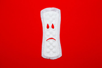 menstruation concept. a menstrual pad on red background