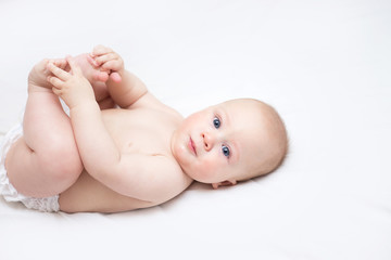 infant lying on a changing table at home