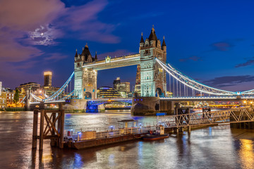 The illuminated Tower Bridge in London, UK, at twilight