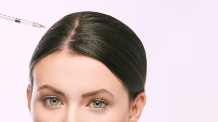 Face needle injection. Young woman cosmetology procedure. Doctor gloves