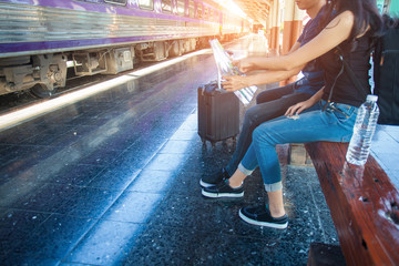 Happy young couple or tourist on railway station platform