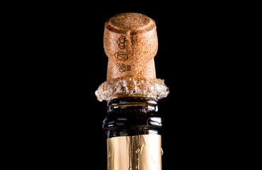 Cork flying from a champagne bottle under the pressure of a liquid