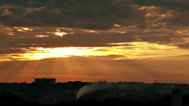 Dramatical timelapse sunrise with sunrays shining through overcast clouds. FullHD 1080p.
