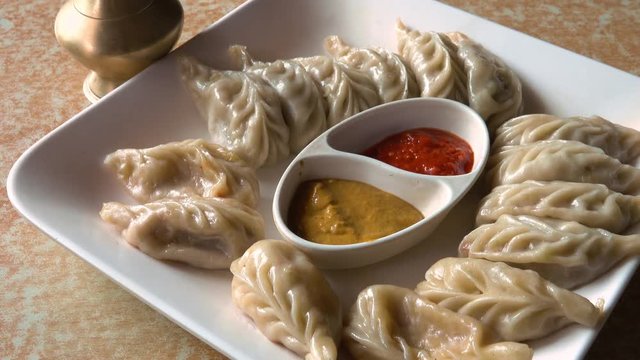Eating Nepalese Traditional Dish Momo. Authentic Cuisine in Nepal
