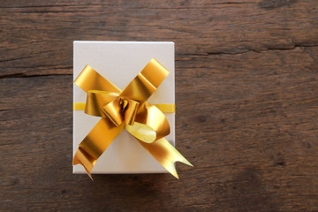 Gift boxes with ribbon on brown wooden background,Top view with copy-space