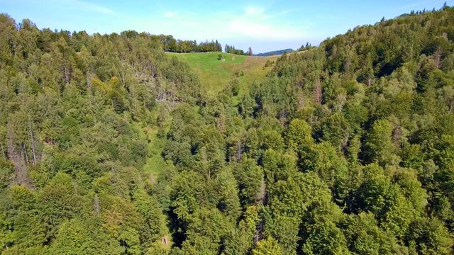 Drone ascends over the mountain top and reveals ridge perspective. FullHD 1080p.