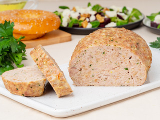 Terrine, meat loaf. Baked Turkey ground meat. Traditional French and American dish. Side view, white marble background