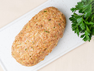 Terrine, meat loaf. Baked Turkey ground meat. Traditional French and American dish. Top view, white marble background