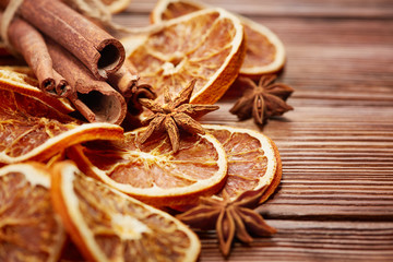 dry orange slices, cinnamon sticks and anise on wooden background - Powered by Adobe