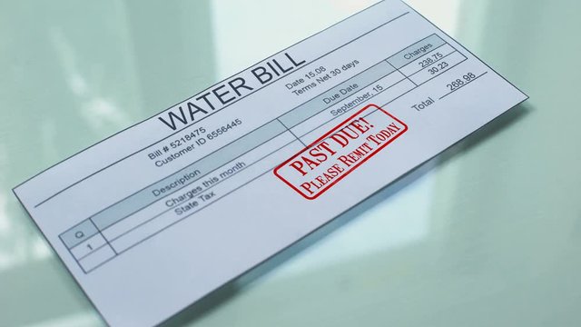 Past due water bill, hand stamping seal on document, payment for services