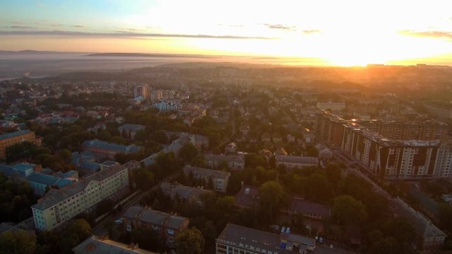 Drone flying over the city at sunrise. FullHD 1080p.