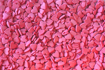 Many pink hearts candy sprinkles background