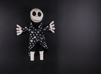 creepy halloween doll on a black background