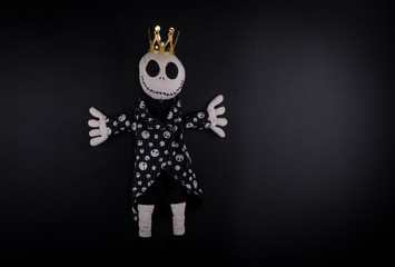 creepy halloween doll on a black background